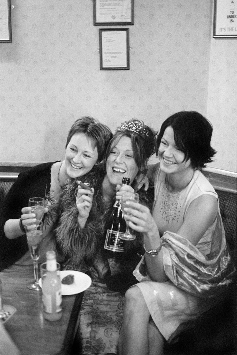 GB. WALES. Cardiff. Butetown - once know as 'Tiger Bay'. The bride, Joanne, and two friends at her Wedding Reception in the Packet Pub, Bute Street, for Graham and Joanne Porter's Wedding. 2000