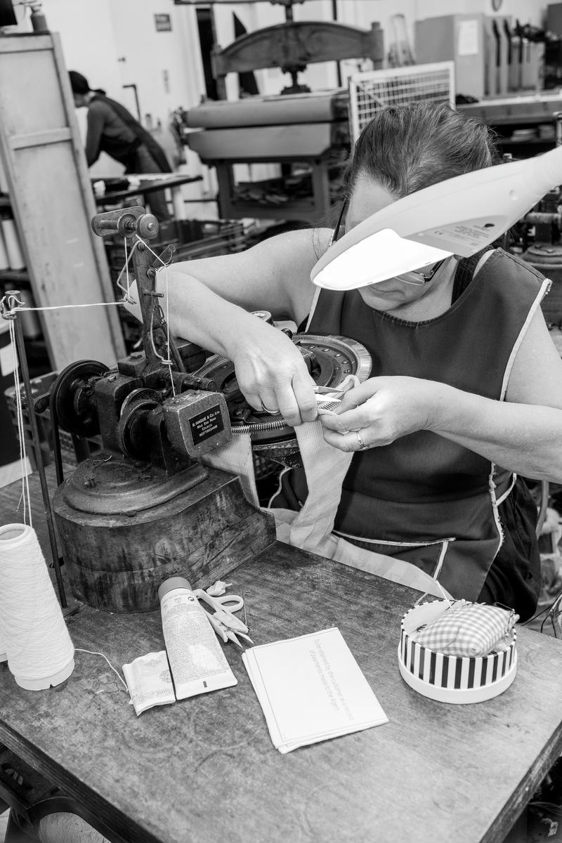 GB. WALES. Ammanford. Corgi Hosiery Ltd. Angie Phillips. Hand finishing socks. 2013.