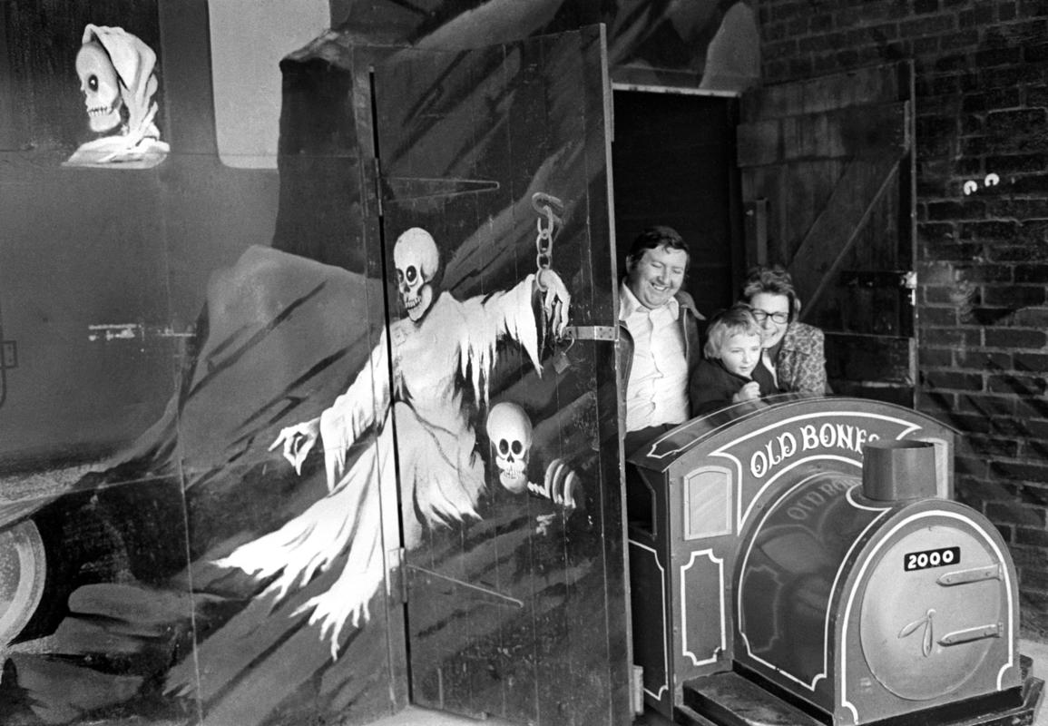 GB. WALES. The fun fair at Porthcawl.  A family have the fun/horror of the Ghost Train. 1974