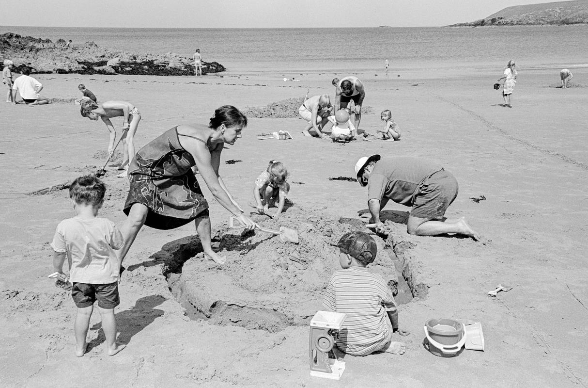 GB. WALES. Porthor. Sandcastle making on the beach. 1997.