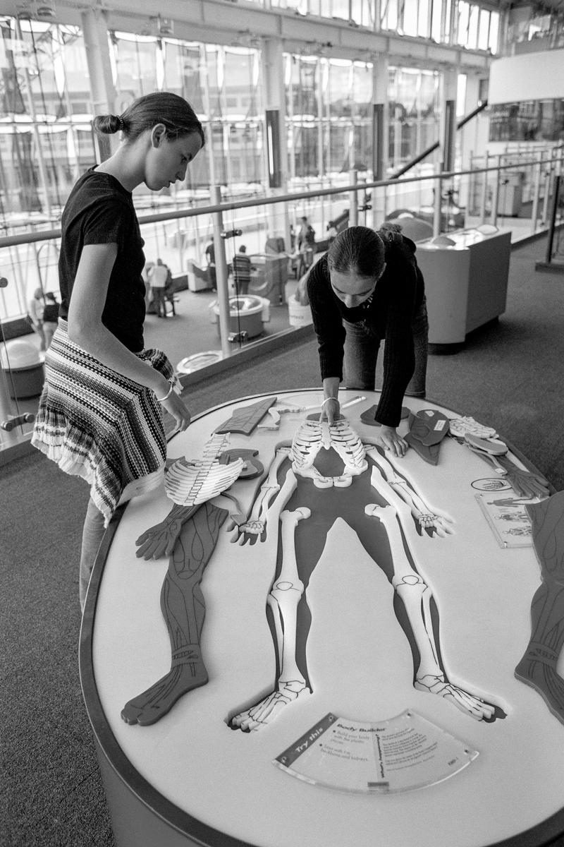 GB. WALES. Cardiff. Bute Town - once known as Tiger Bay. Children experimenting at Techniquest, the interactive Science Museum on Stuart Street on the edge of the bay. 2003