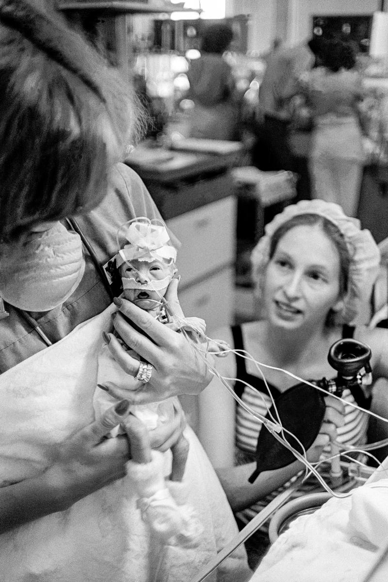 Preemie Baby unit at St Joseph's Hospital. Even at 1lb 14oz a baby can be picked up without breaking. The nurse shows how to the mother in the background.