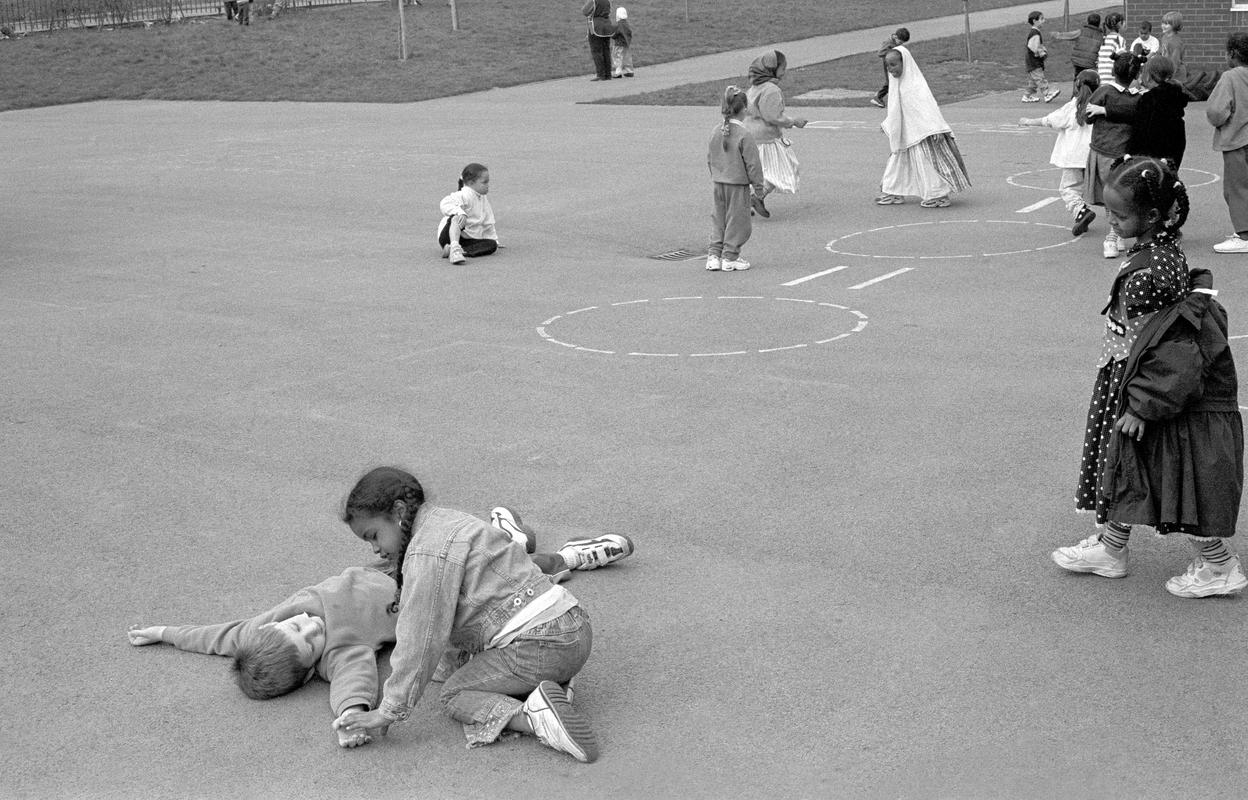 GB. WALES. Cardiff. Butetown - once know as 'Tiger Bay'). Mixed cultures of St Mary's school during playtime. 2000