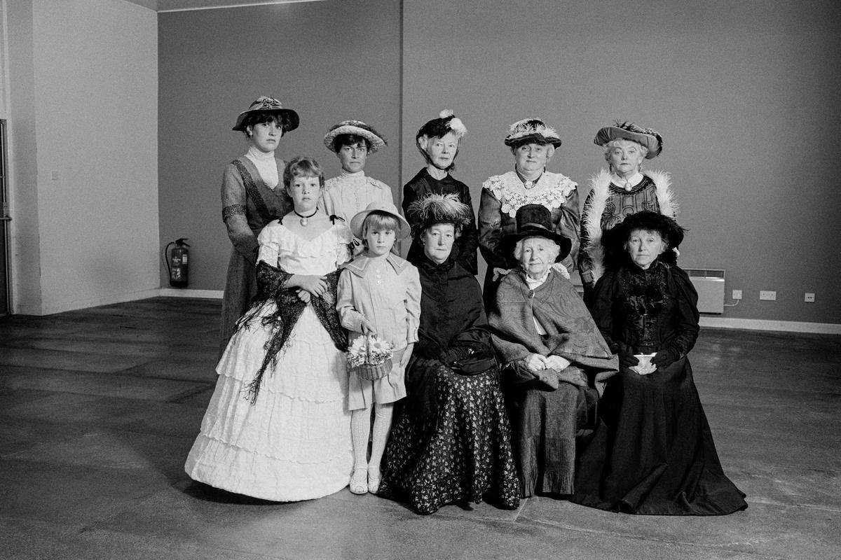 GB. WALES. Criccieth. A century of fashion featuring clothes worn by the family of Lloyd George.  The main dress was made for Lady Megan Lloyd George.  The Shawl is over 150 years old, made in Paisley in Scotland this was the Shawl to aspire to rather than the common Welsh white flannel.  The group are seen in the Criccieth Town Hall where David Lloyd George developed his style of oratory in local competition. 1986