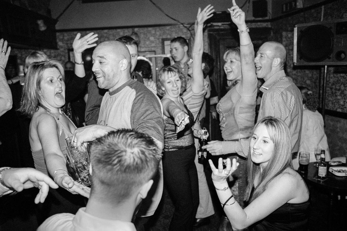 GB. WALES. Cardiff. Butetown - once know as 'Tiger Bay'. Regulars in the Ship & Pilot pub celebrating Michael Burrows Jnr's last night as Landlord. The pub is one of the oldest in the district. 2003.