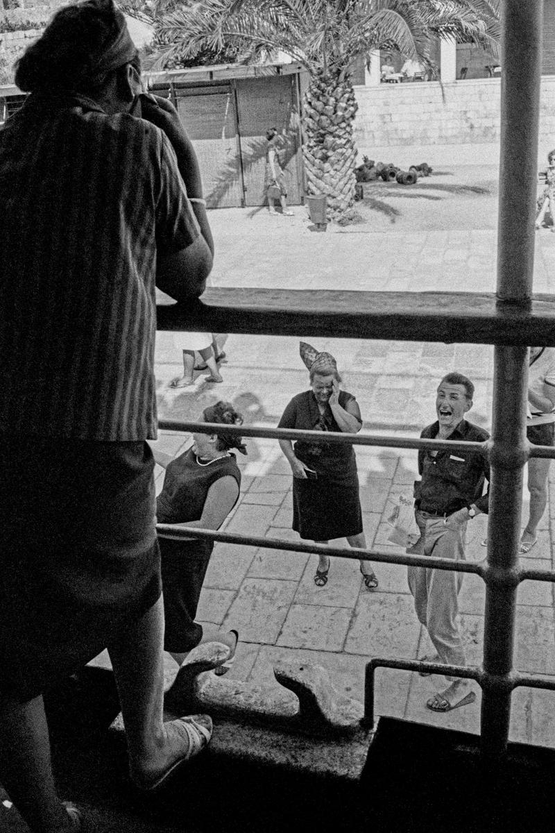 CROATIA (was Yugoslavia). Dubrovnik. Tourists on a boat, are seen off by friends, in the docks. 1964.