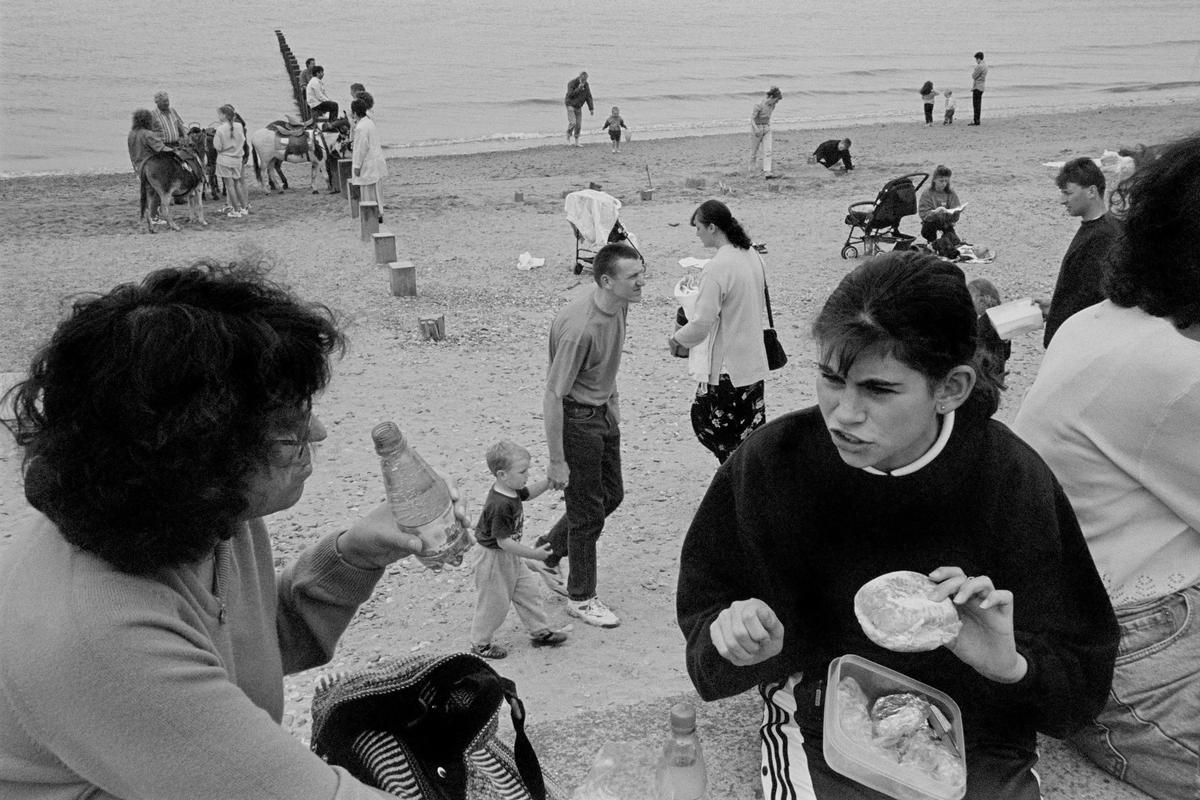 GB. WALES. Rhyl. Family group. The promenade and sands. 1997