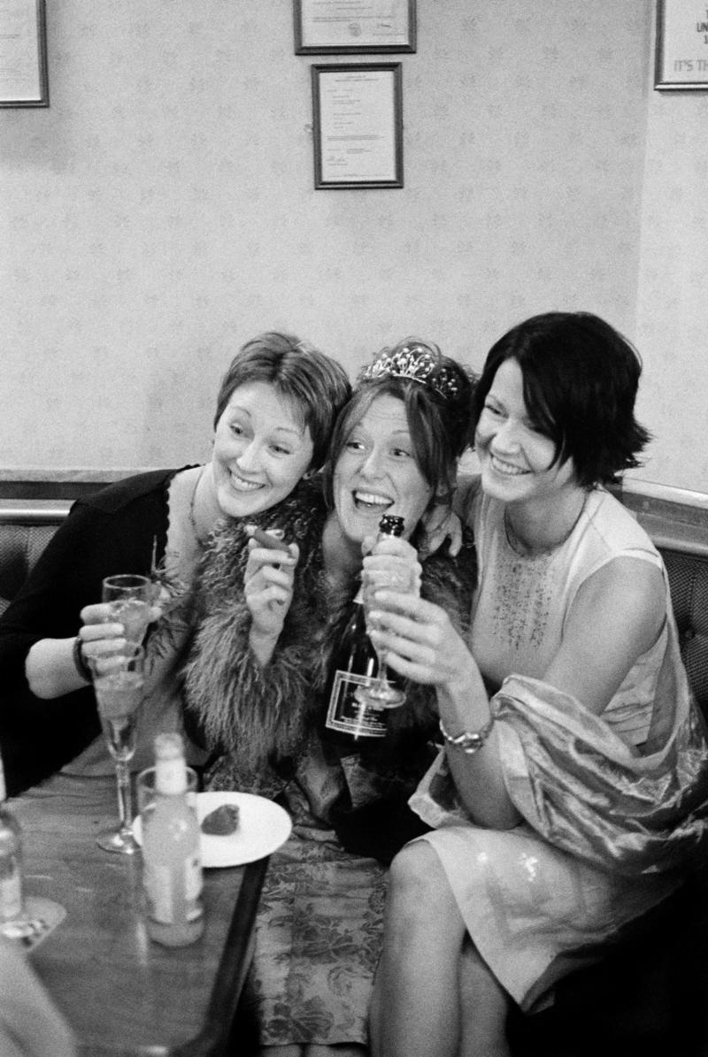 GB. WALES. Cardiff. Butetown - once know as 'Tiger Bay'. The bride, Joanne, and two friends at her Wedding Reception in the Packet Pub, Bute Street, for Graham and Joanne Porter's Wedding. 2000