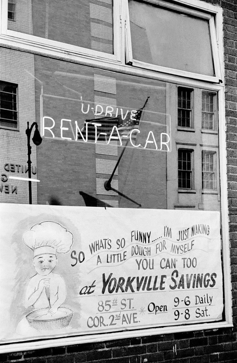 USA. NEW YORK. Lower Manhattan. Rent a Car. Savings and American Flag. 1962.