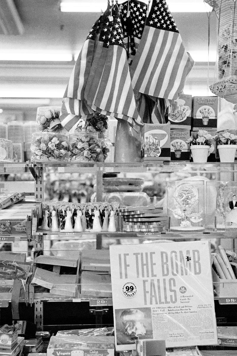 USA. NEW YORK. Lower Manhattan. Woolworth Shop & Ban the Bomb record. Plus the American Flag. 1962.