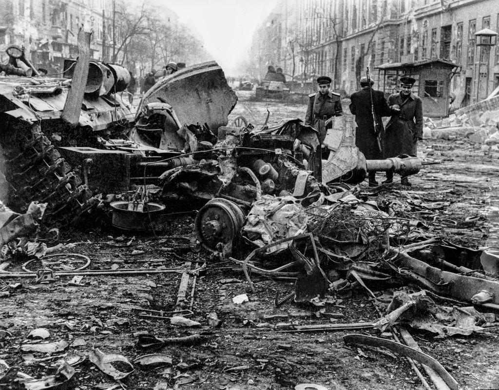 HUNGARY. BUDAPEST. Hungarian Revolution. Freedom fighters in Budapest during a lull in the fighting talk to other freedom fighters and examine the remains of a Russian tank. 1956.