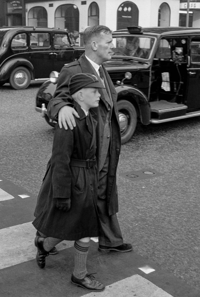 GB. ENGLAND. London. Soho. A father and schoolboy son walk in central London. Taken on a Contax 2 camera (first professional camera). 1958.