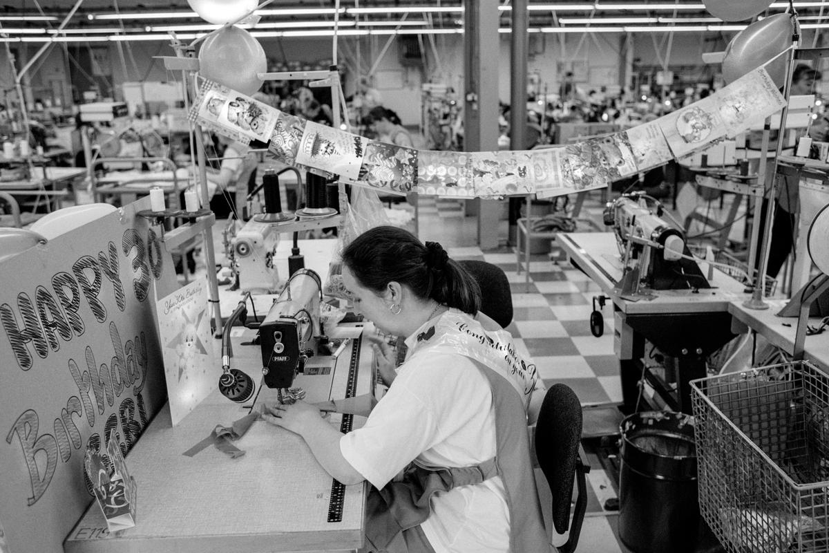 GB. WALES. South Wales employment. Gossards. For over 100 years manufacturers of Lingerie in the South Wales valleys. 65% of the workforce have worked with the firm for over 10 years. Most of the lingerie is made by hand. The workers work in teams of 15 and work out their own speed of output. Birthdays are a major event celebrated by all. 1998.