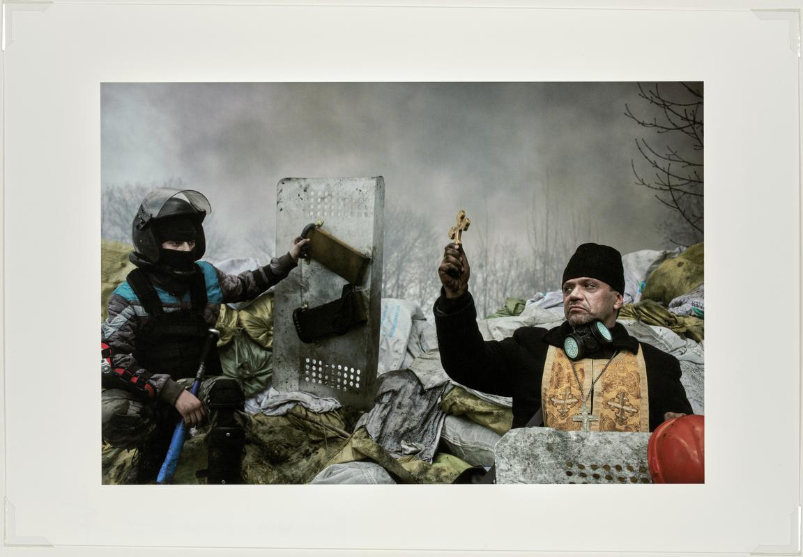 An Orthodox priest blesses the protesters on a barricade. Kiev, Ukraine