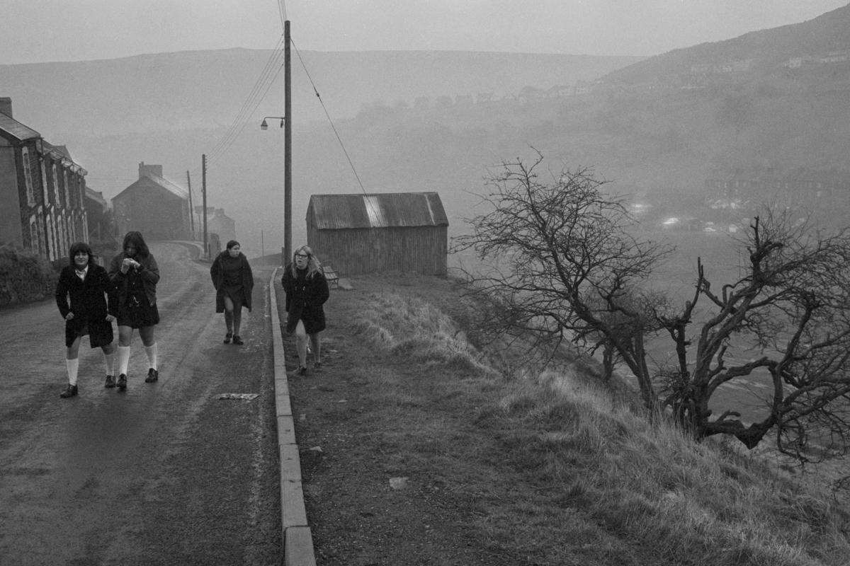 GB. WALES. Abertillery. The morning walk to school in the rain. 1973.