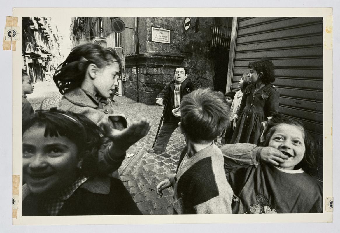 Children and a beggar. Naples, Italy